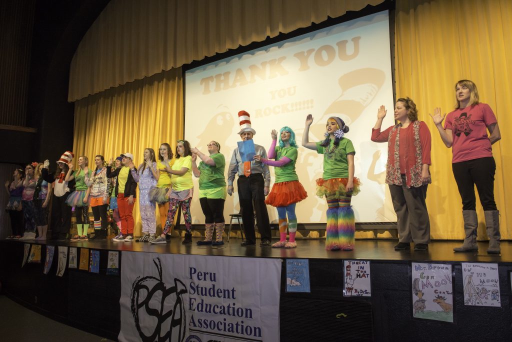 Group of students and educators in front of the performing arts stage during Dr. Seuss Day