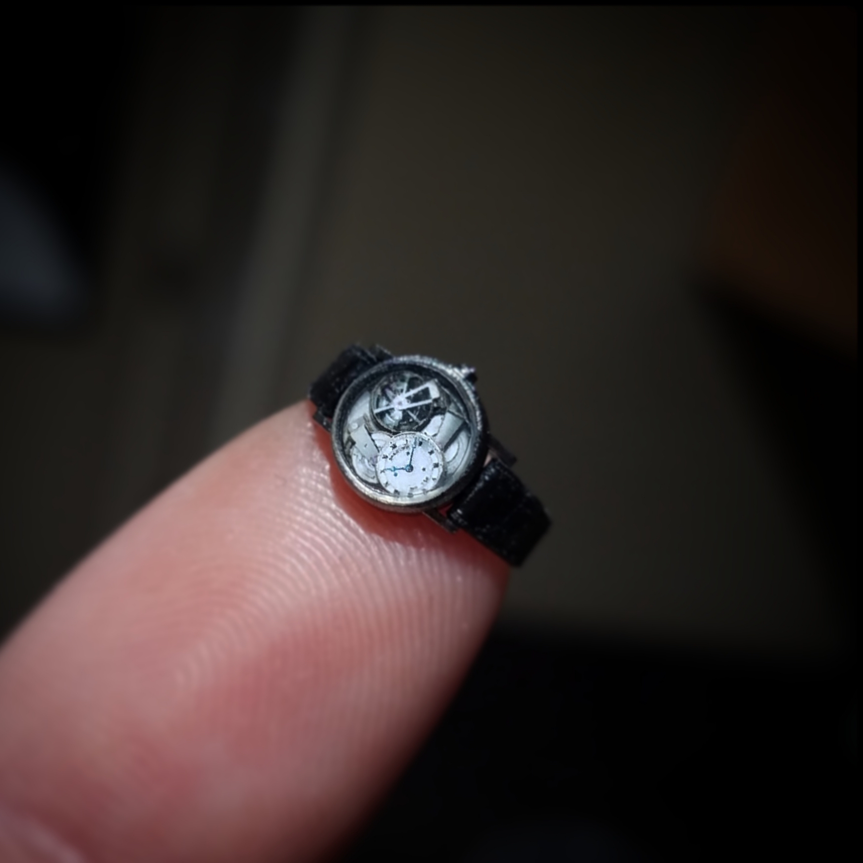 fingertip with tiny watch
