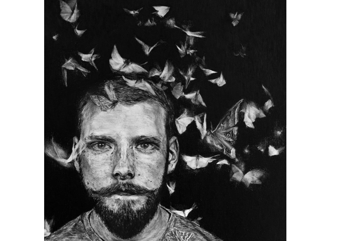 Black and white picture of a bearded man's head surrounded by dozens of butterflies in flight