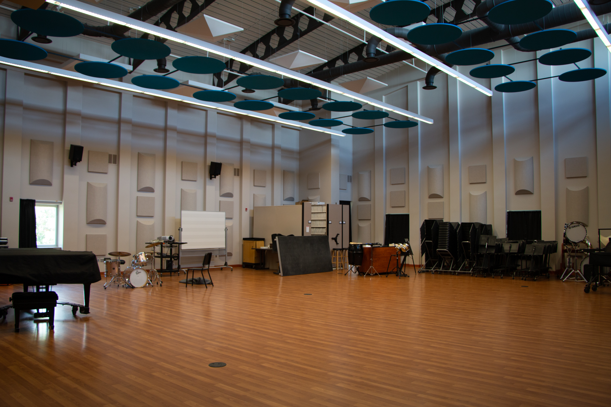Jindra Band Room with chairs, music stands, and baby grand piano