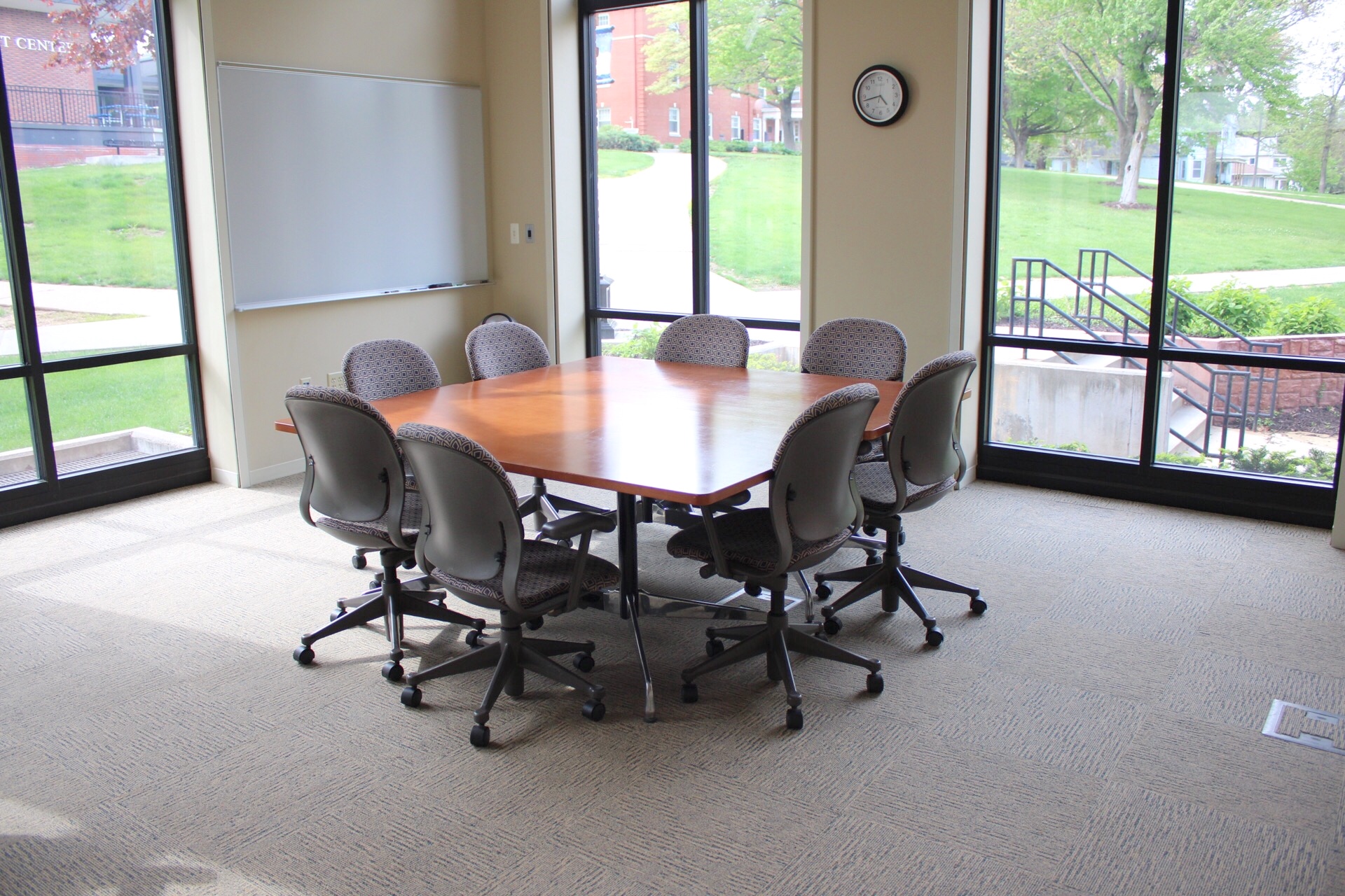 North end of the CATS conference room showing tables and chairs and a whiteboard.