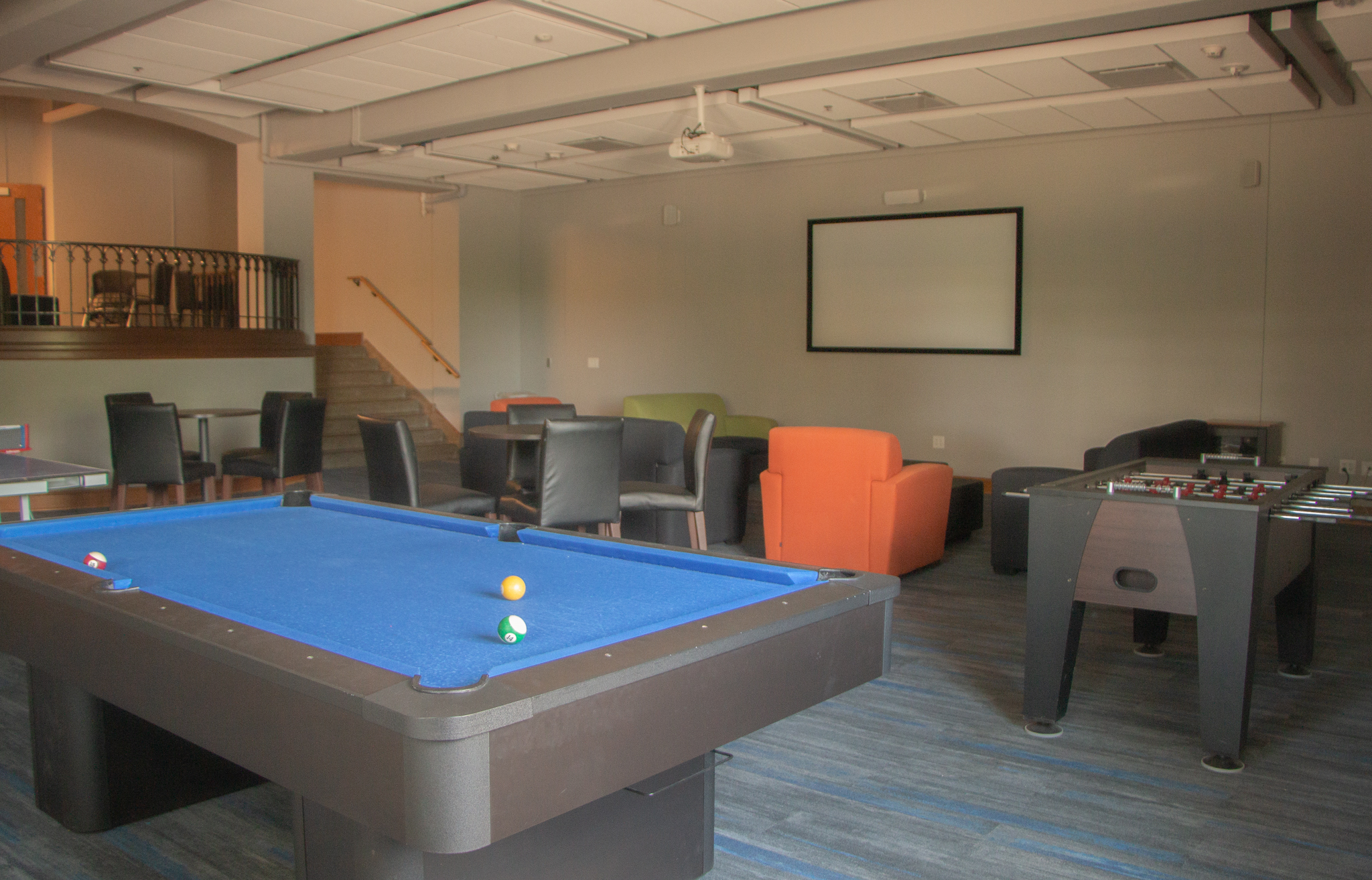Delzell Game room with pool table, foosball table and seating areas.