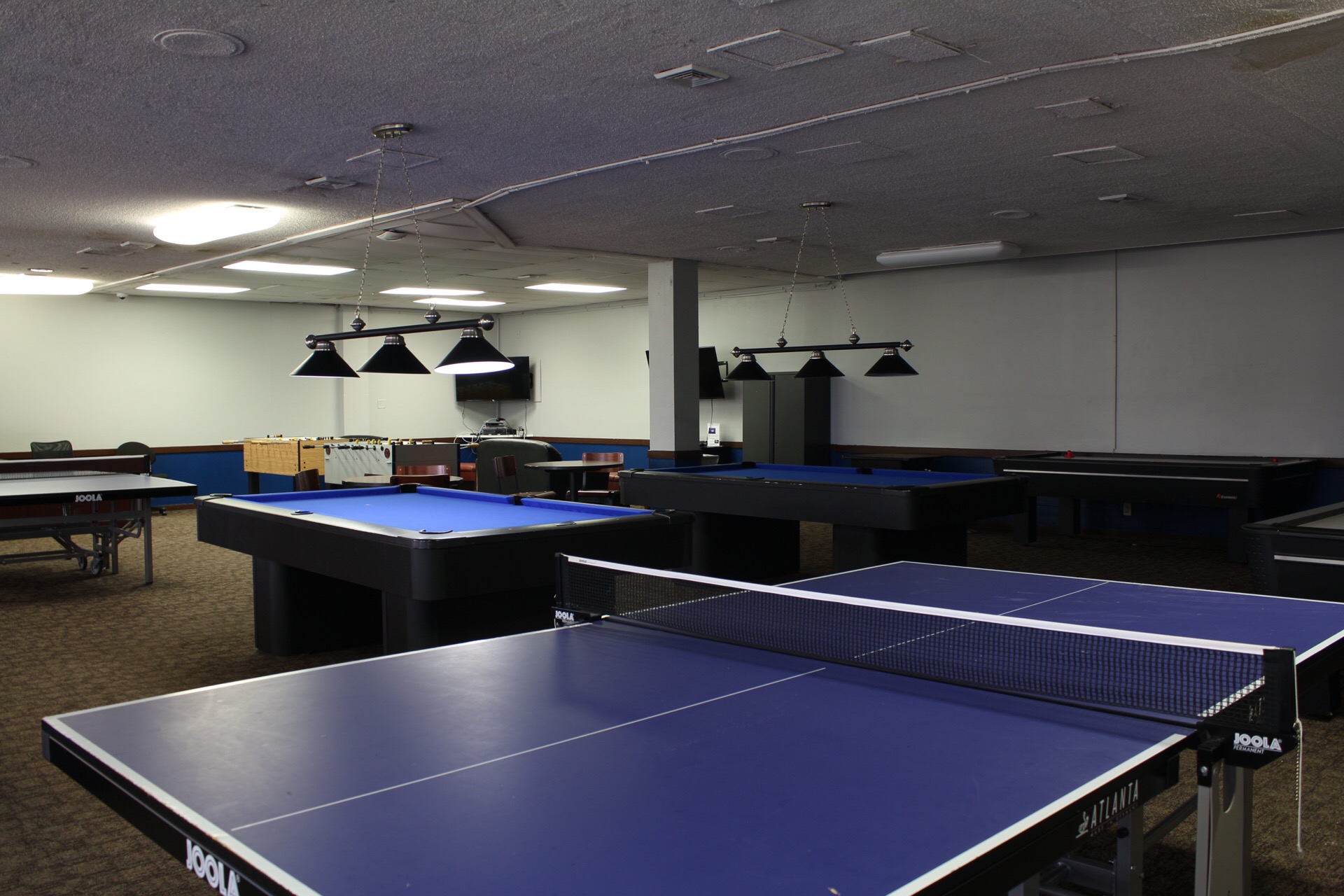 Game Room with ping pong tables, pool tables and foosball stations.