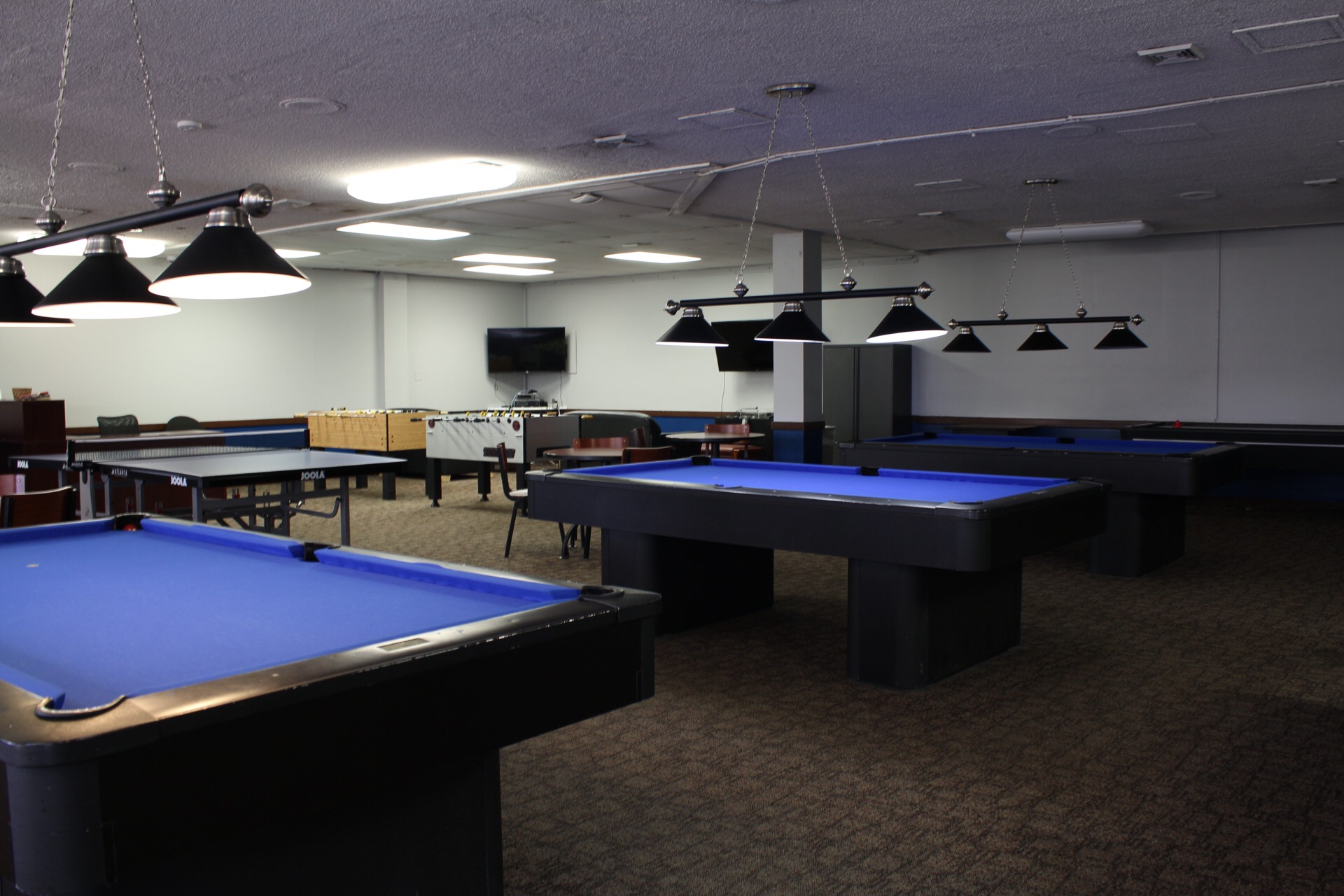 Game Room showing pool tables, ping pong tables and foosball stations.