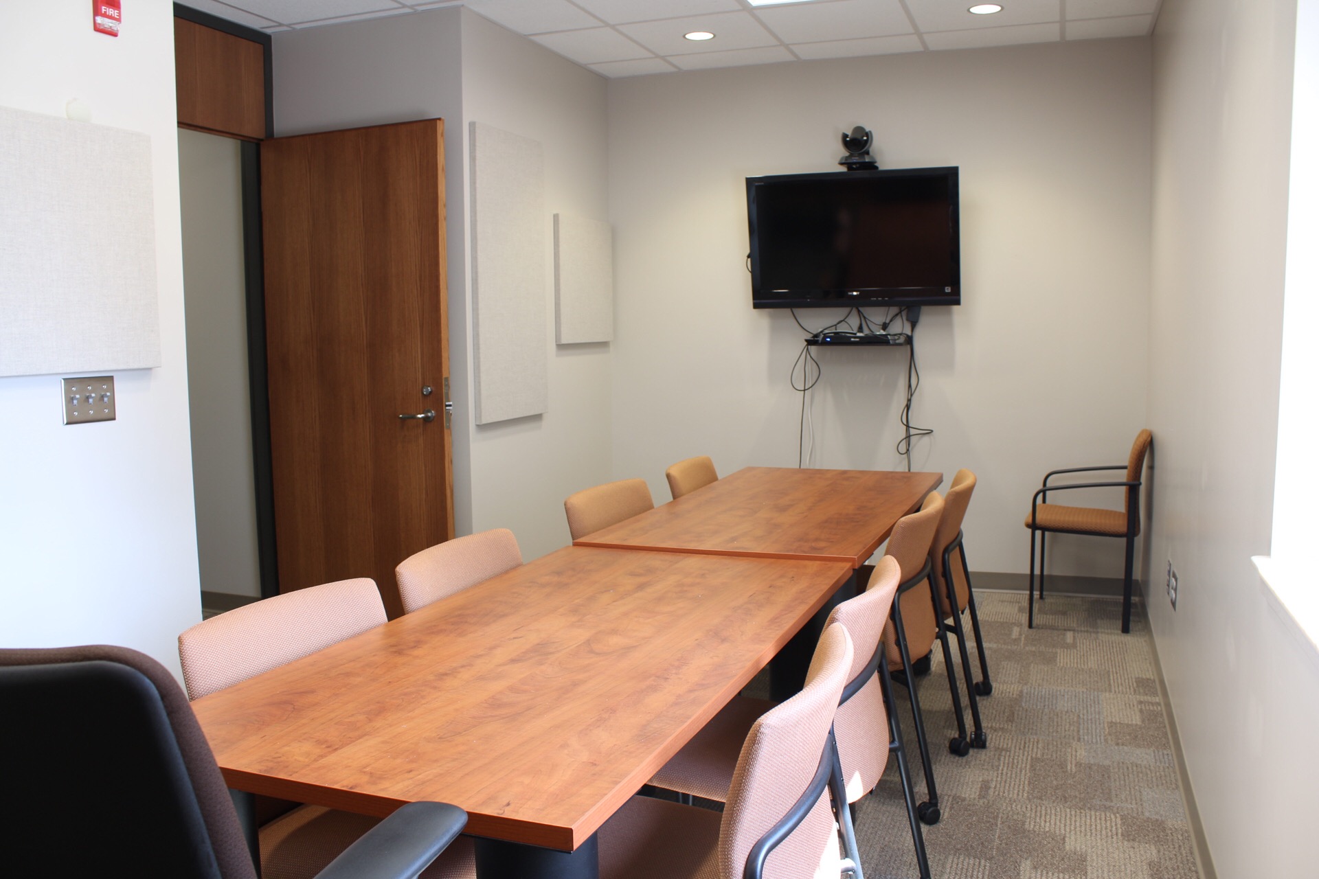 Jindra Conference Room with 2 tables, 10 chairs and wall mounted tv and vcr.