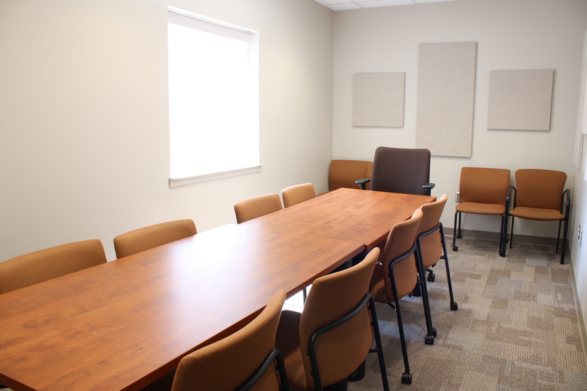 Jindra Conference Room showing 2 tables, and additional seating.