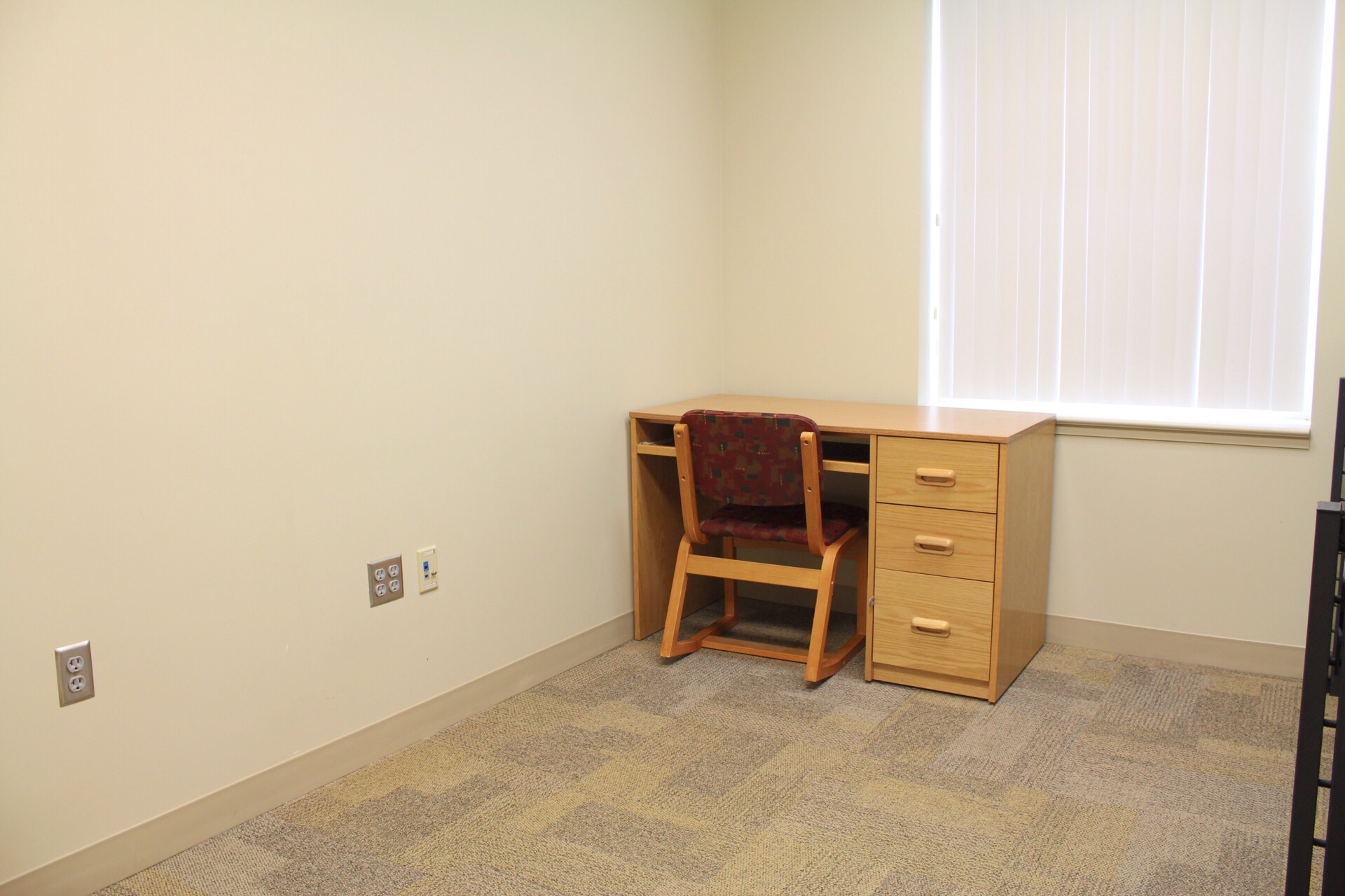 Morgan Hall room with desk and chair located by a window.