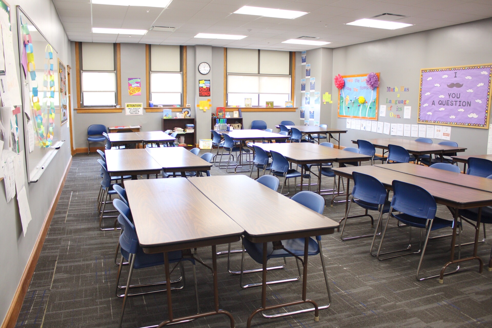 TJ Majors 230 with tables, chairs, white boards and decorated bulletin boards.