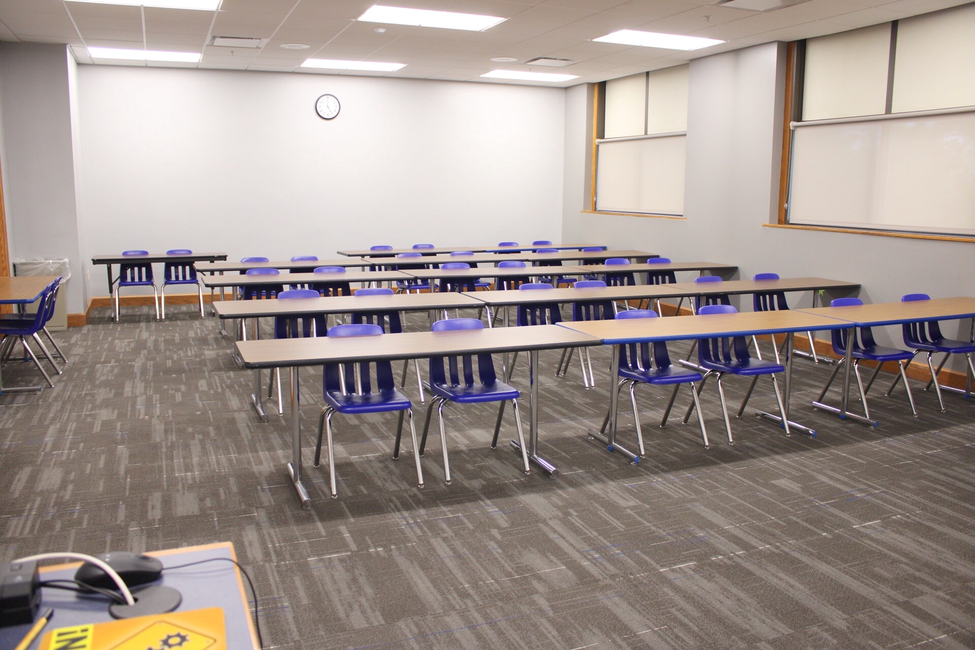 TJ Majors 302 viewed from the front of the classroom showing 5 rows of tables and chairs.