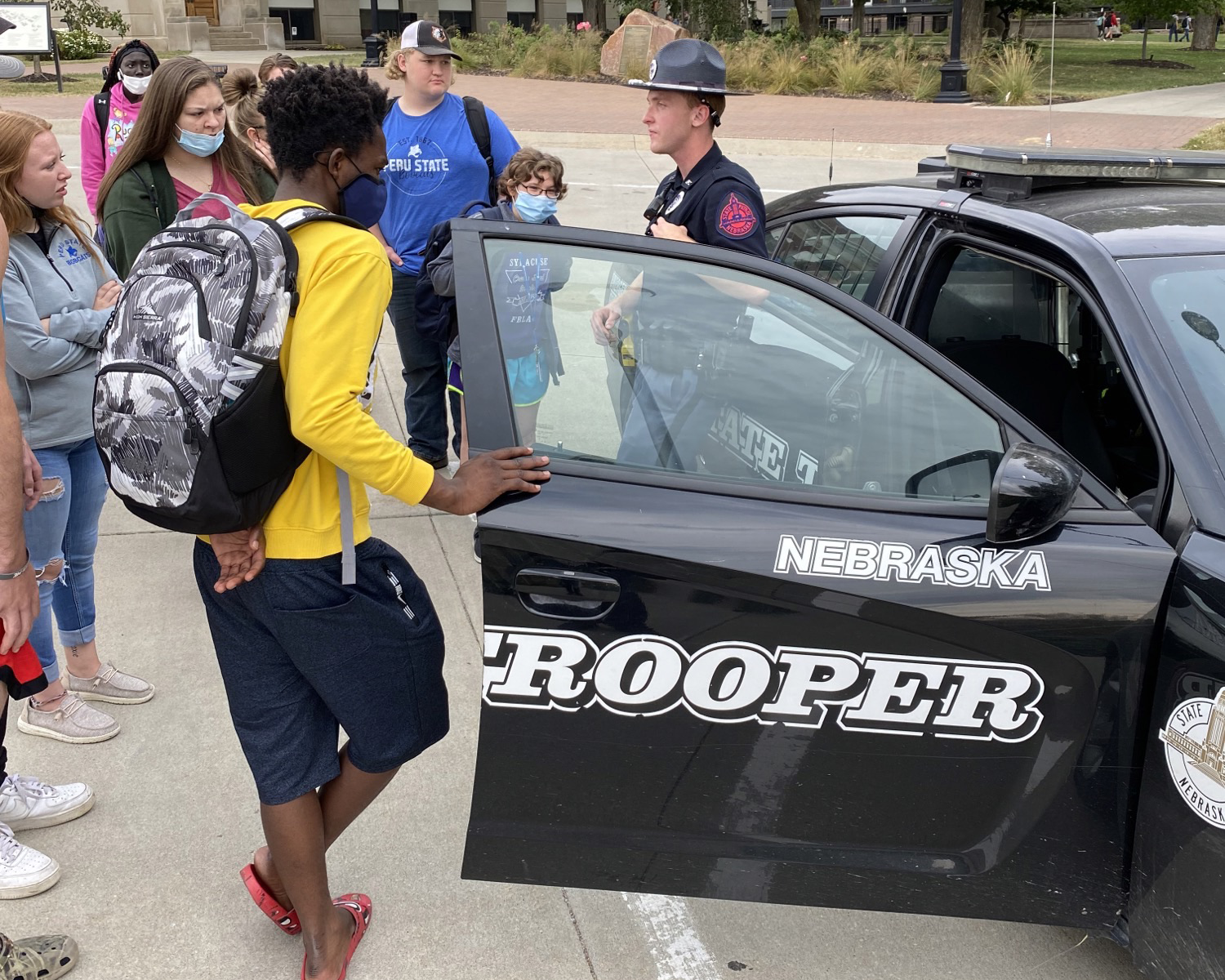 Students in front of a squad car