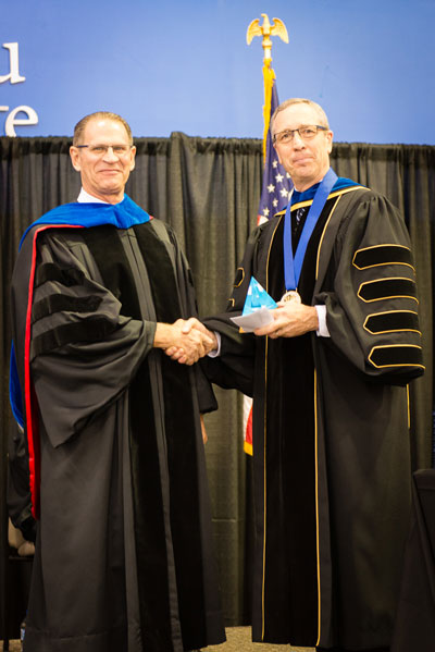 Dr. Asmussen receives his award from Dr. Hanson
