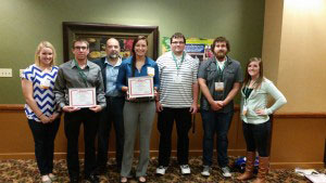 Group of conference attendees with their awards.