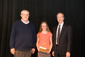 Erv Friesen (left), presents the “We Proceeded On” award from the Missouri River Basic Lewis and Clark Center to Christina Lillenas with Dr. Dan Hanson, President of Peru State College (right).