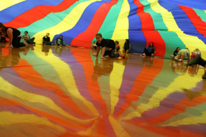 HTRS sixth grader, Lily Bradshaw, tradings spots under the parachute tent.