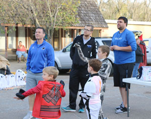 The Peru State Men's Basketball Team hosted games at the Trunk-or-Treat downtown. Eric Behrens, Matt Crouch and Ben Cruickshank watch as Preston Crawford, Ross Goering and Weston Paschal play.