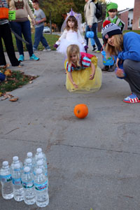 Roux Neveau bowling with a pumpkin as part of the science club's Boo Bash games!