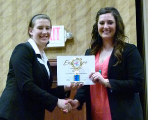 Lauren Robertson (right) accepts first place for Website Design. Millie Anderson and Melissa Jasso not pictured.