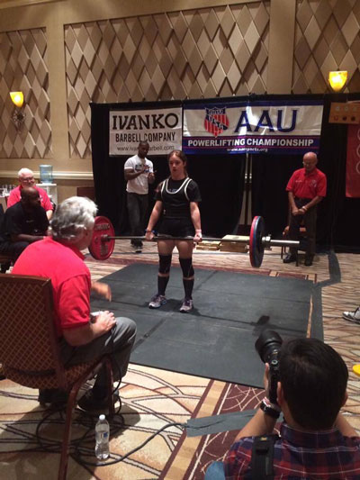 Kuhlman competing in Las Vegas with judges, media and other personnel around her.