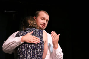 Ethan A. Fricke comforts Tristan Petz in their roles as husband and wife.