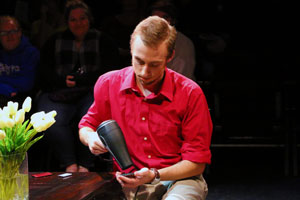 Wesley McCord blow drying a cell phone.