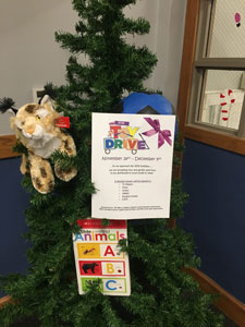 Toy Drive flyer on evergreen tree.