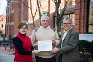 Paul Fish accepts a certificate declaring the Gran Fondo a signature event from members of the Nebraska State Sesquicentennial Commission, Dr. Sara Crook and Dr. Dan Holtz.