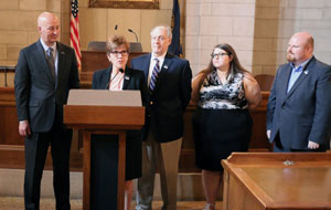 Dr. Sara Crook speaking on behalf of the Sesquicentennial Planning Committee and Peru State College. Governor Ricketts stands to the left. Dr. Spence Davis, professor of history; Michelle Kaiser, Peru State alum; and Jason Hogue, Director of Marketing and Communications, also attended.