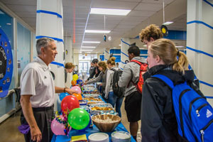 Ted Harshbarger and the Professional Staff Senate serves desserts to students.