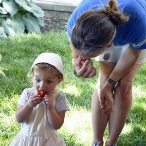 Marie shares a strawberry with her mother, Kimmie Vogt.