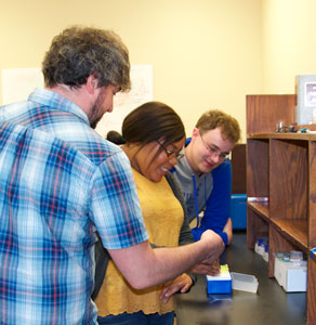 Dr. Nate Netzer working with student researchers, Carlene Riley and Dylan George.