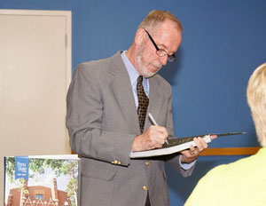 Dan Sullivan signing a copy of the new book. Photo by Dr. Bill Clemente.
