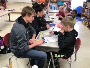 Teacher candidates working with elementary students.
