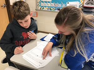 A teacher candidate working with a student.