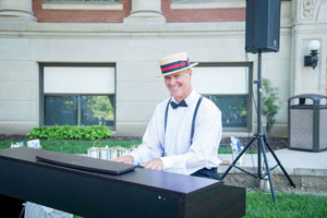 Marty Mincer plays ragtime piano during the Charter Day reception.