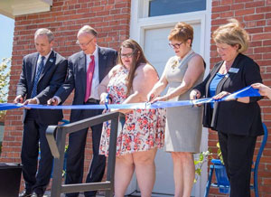 The ribbon being cut by Dr. Dan Hanson, president of Peru State; George Blazek; Nelson Family Foundation Trustee; Michelle Kaiser, former president of Phi Alpha Theta; Dr. Sara Crook, Phi Alpha Theta Advisor; and Joyce Douglas, president of Peru State's Foundation Board.