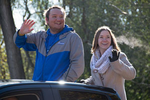 2016 Homecoming King Robbie Gilbert and Homecoming Queen Chelsea Reznicek wave from the back of a truck loaned to the Peru State Student Senate by Larson Motors.