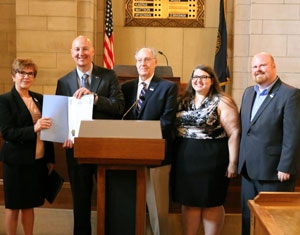 Dr. Sara Crook and Governor Pete Ricketts show the signed proclamation. Dr. Spence Davis, professor of history; Michelle Kaiser, Peru State alum; and Jason Hogue, Director of Marketing and Communications, also attended the ceremony.