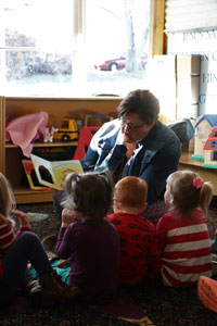 Dr. Gina Bittner, AIM's faculty advisor, reading to preschoolers.