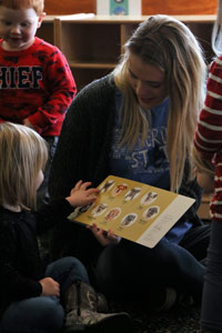 Serena Nelson, AIM's co-president, reading to preschoolers.