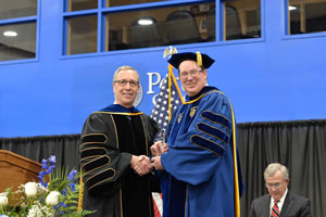 Welsh and Hanson appear on the Peru State commencement stage.