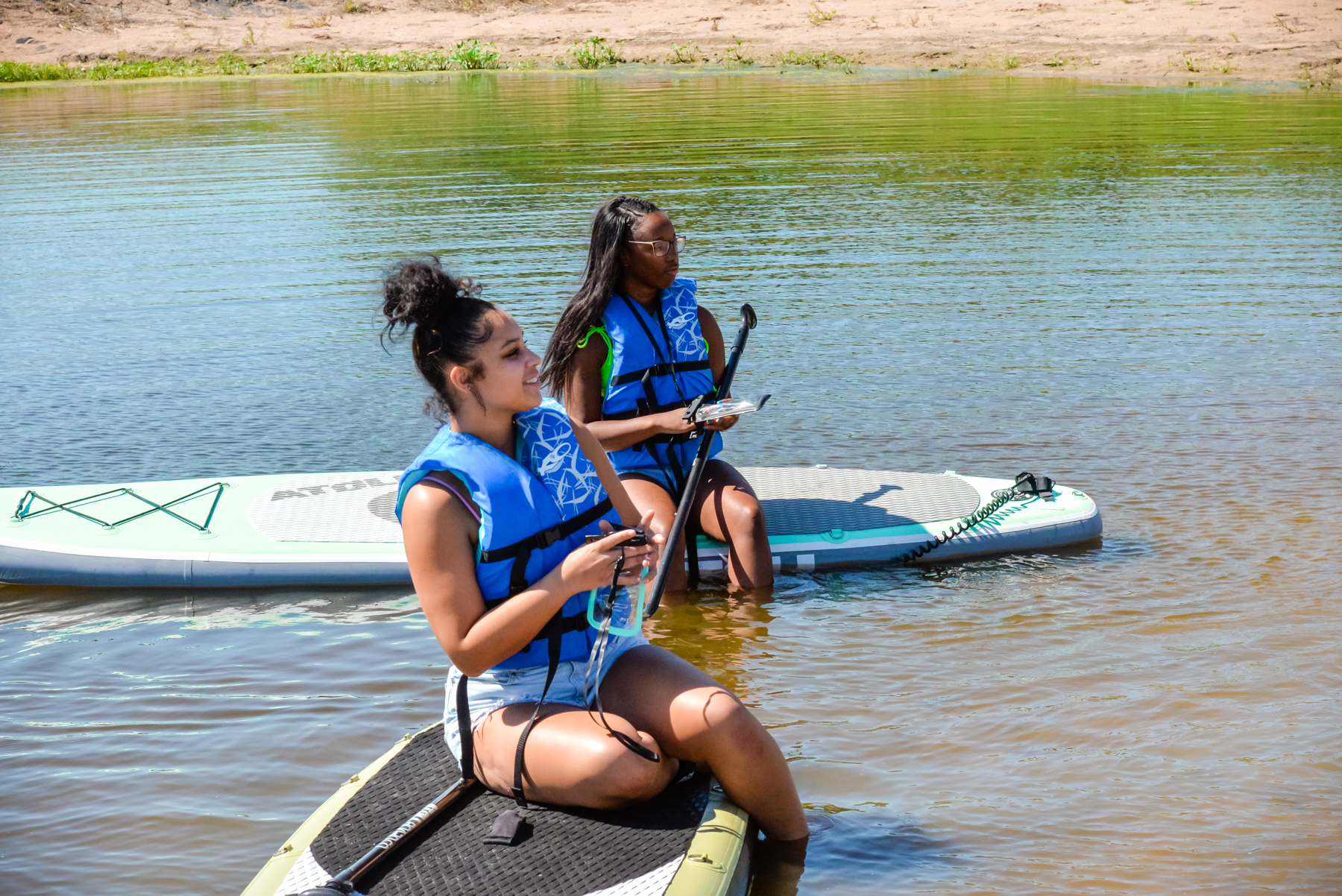 Peru State students practice paddleboarding.