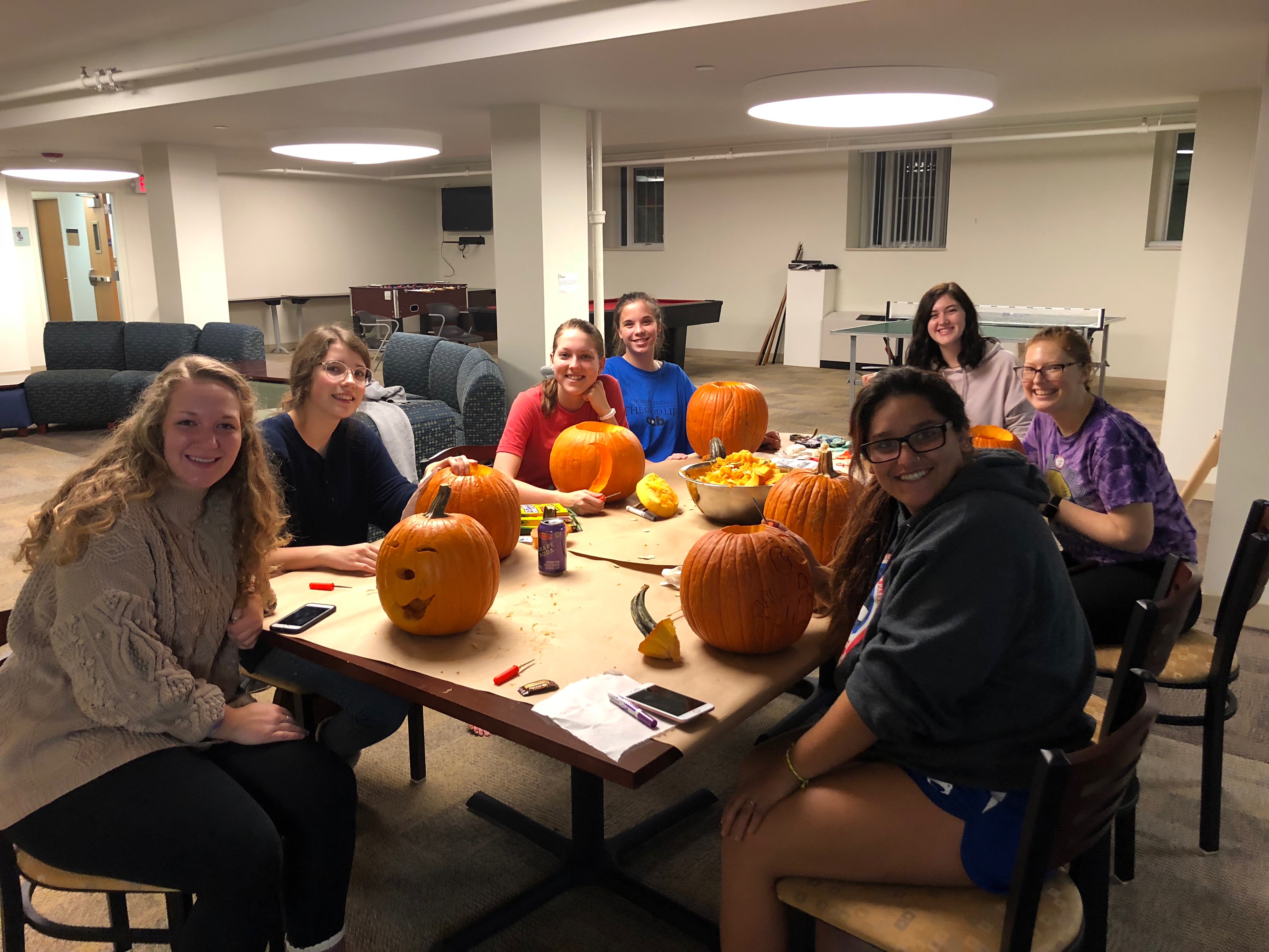 Students decorating pumpkins