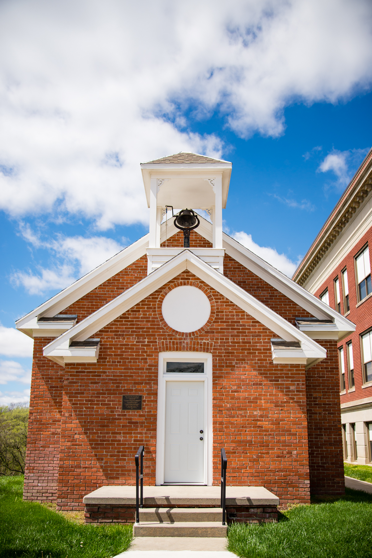 This is an exterior shot of the Visitor Center, also known as the Little Red Schoolhouse. The Visitor Center is located between AV Larson and TJ Majors buildings.